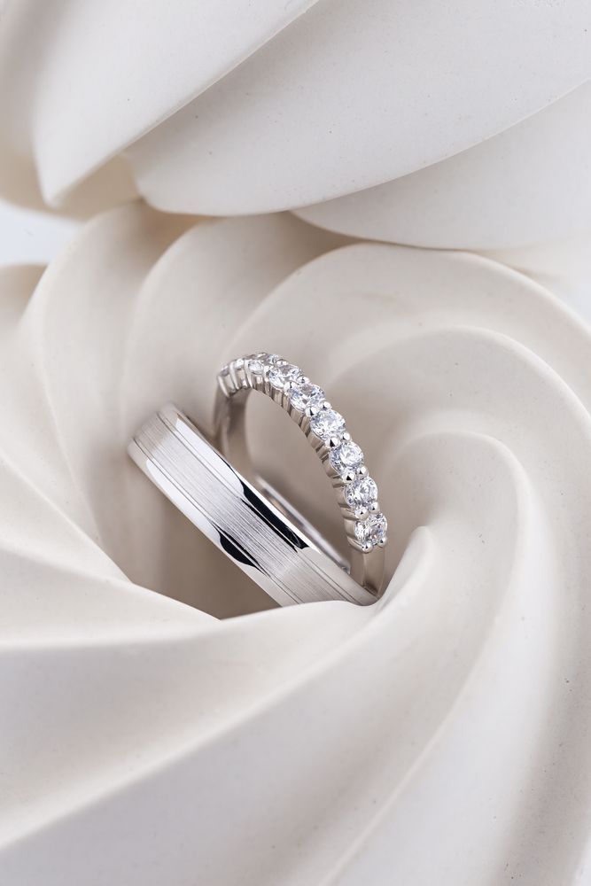 A Couple of Wedding Rings Are Sitting on Top of a White Cloth — K. Smith & Son Jewellers In Caloundra, QLD