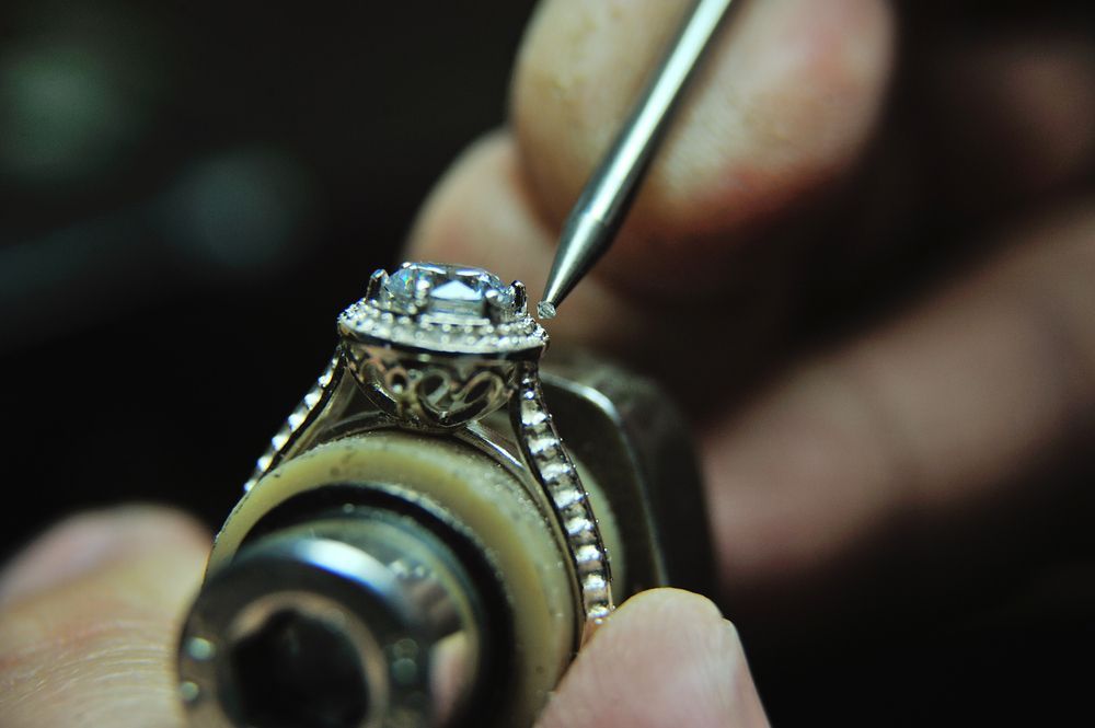 A Person is Working on a Ring With a Tool — K. Smith & Son Jewellers In Caloundra, QLD