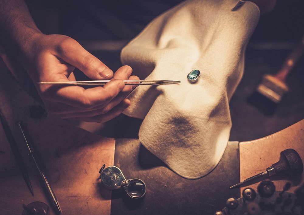 A Person is Cleaning a Ring With a Cloth — K. Smith & Son Jewellers In Caloundra, QLD