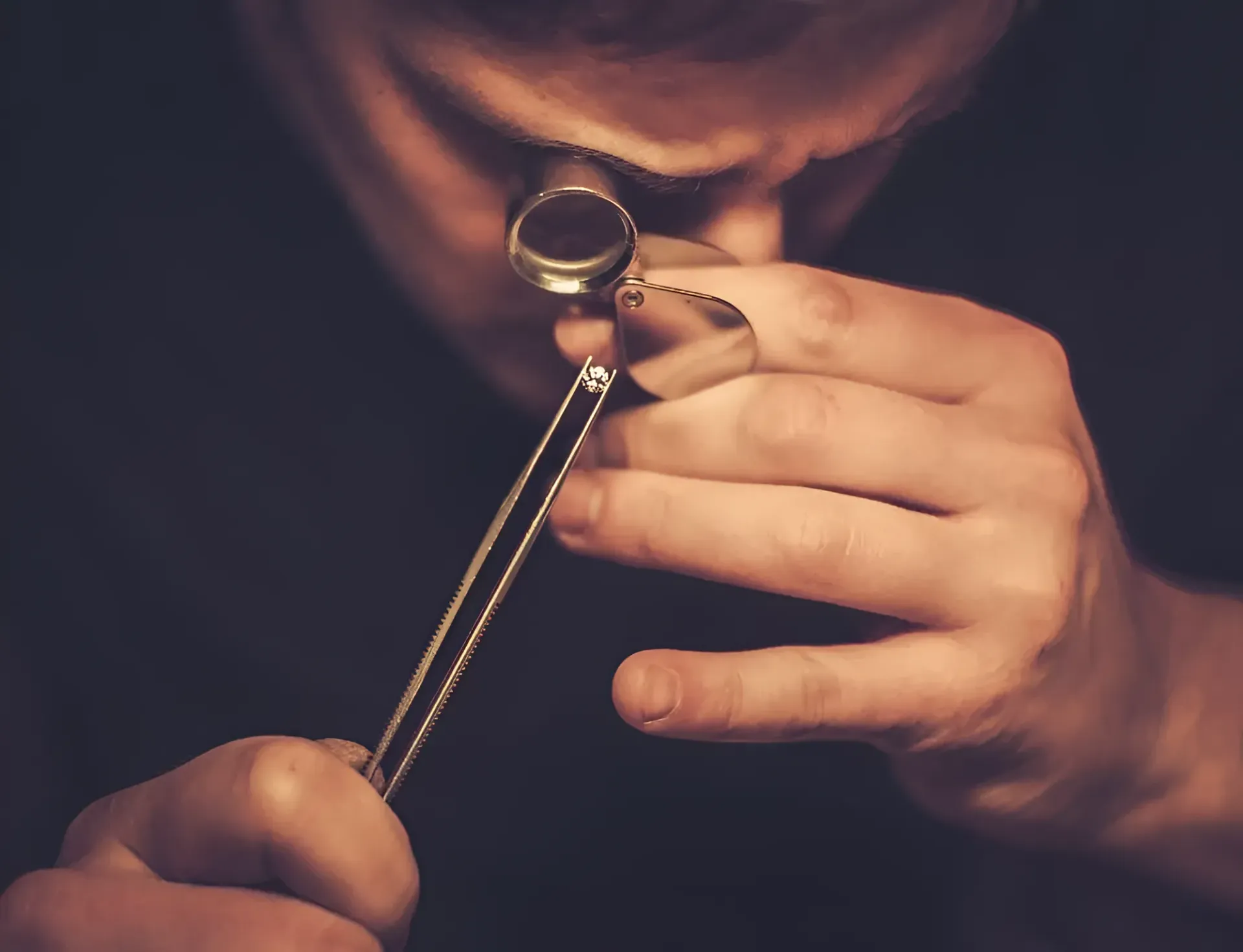 A Man is Looking Through a Magnifying Glass at a Necklace — K. Smith & Son Jewellers In Caloundra, QLD