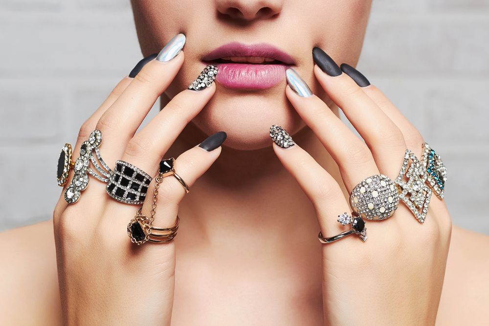 A Woman is Wearing a Lot of Rings on Her Hands — K. Smith & Son Jewellers In Caloundra, QLD
