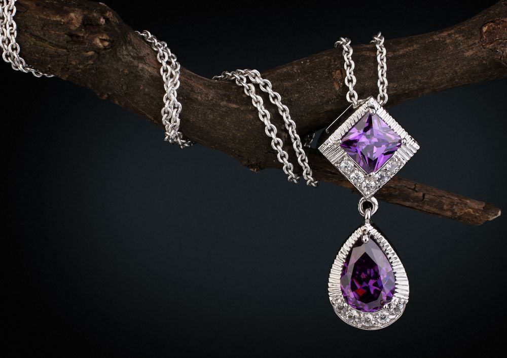A Necklace With a Purple Stone Hanging From a Tree Branch — K. Smith & Son Jewellers In Caloundra, QLD