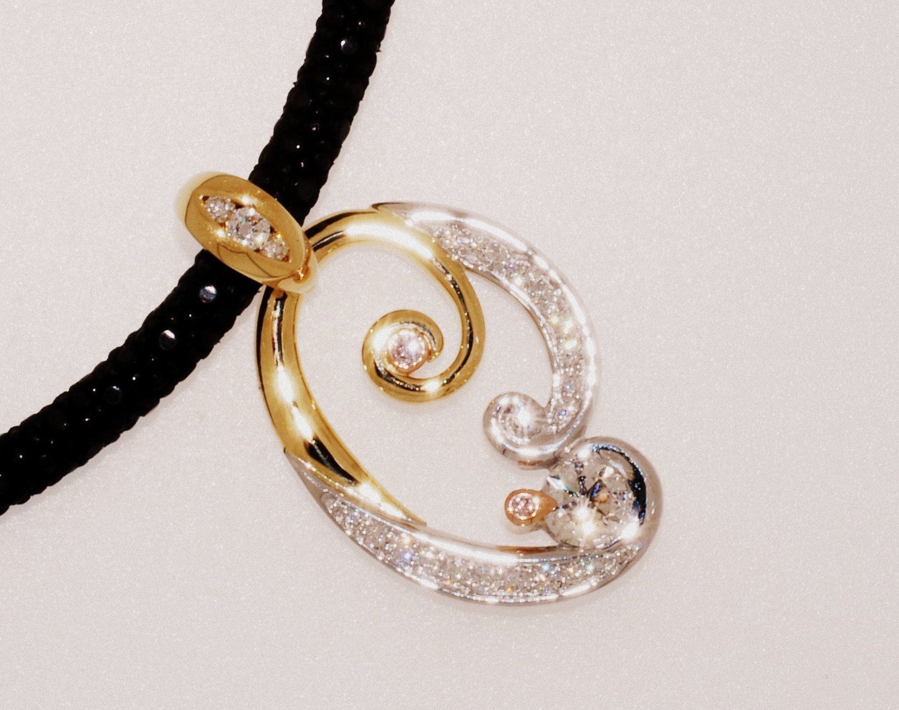 Gold and diamond pendant on a black beaded necklace. The pendant features a swirl design — K. Smith & Son Jewellers In Caloundra, QLD