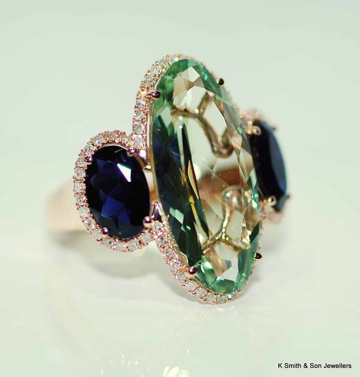 Rose Gold Ring with A Large Oval Green Gemstone Flanked by Two Oval Blue Gemstones — K. Smith & Son Jewellers In Caloundra, QLD