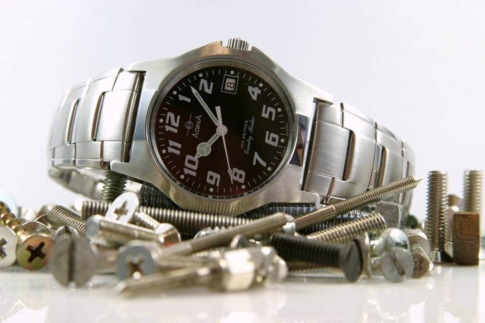 Silver Wristwatch Surrounded by Screws and Other Small Hardware — K. Smith & Son Jewellers In Caloundra, QLD