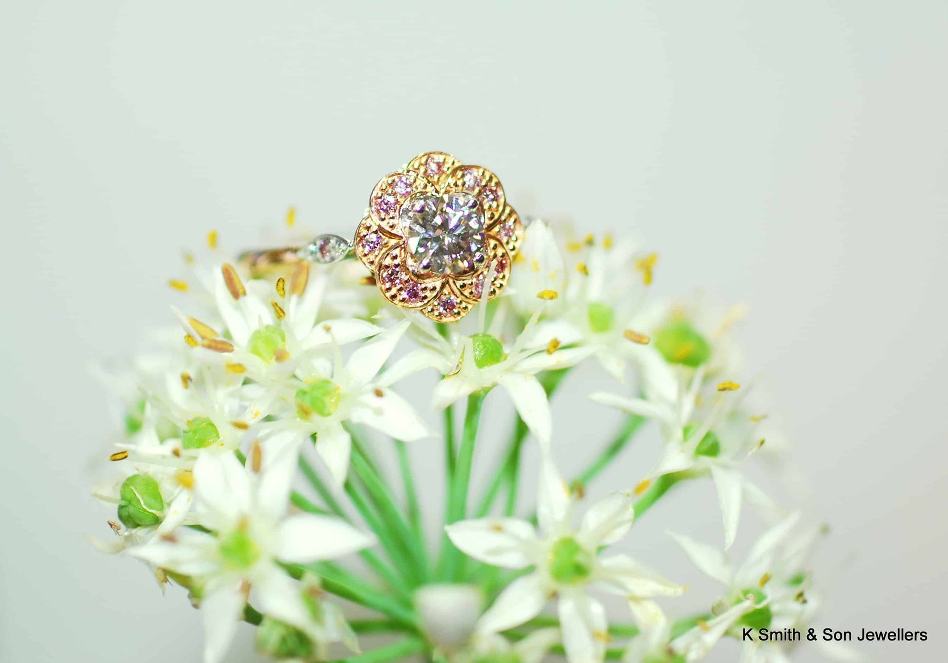 A Ring is Sitting on Top of a Bunch of White Flowers — K. Smith & Son Jewellers In Brisbane, QLD
