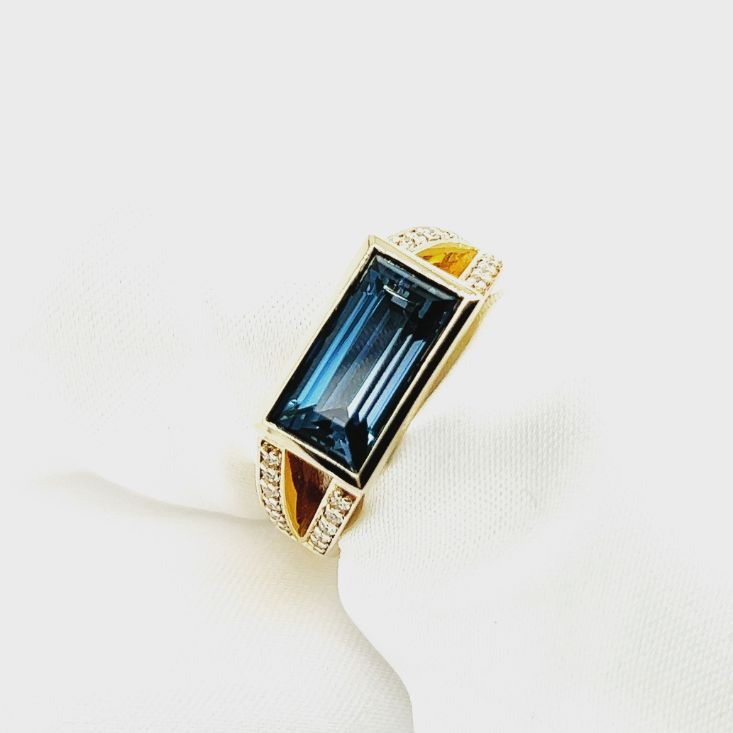 A Gold Ring With a Blue Stone and Diamonds — K. Smith & Son Jewellers In Caloundra, QLD