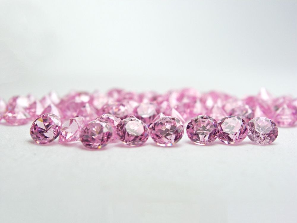 A Bunch of Pink Stones Are Sitting on a White Surface — K. Smith & Son Jewellers In Caloundra, QLD