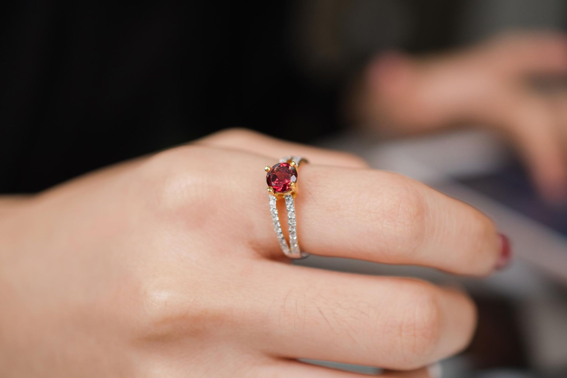 A Hand Wearing a Gold Ring With a Red Gemstone — K. Smith & Son Jewellers In Caloundra, QLD