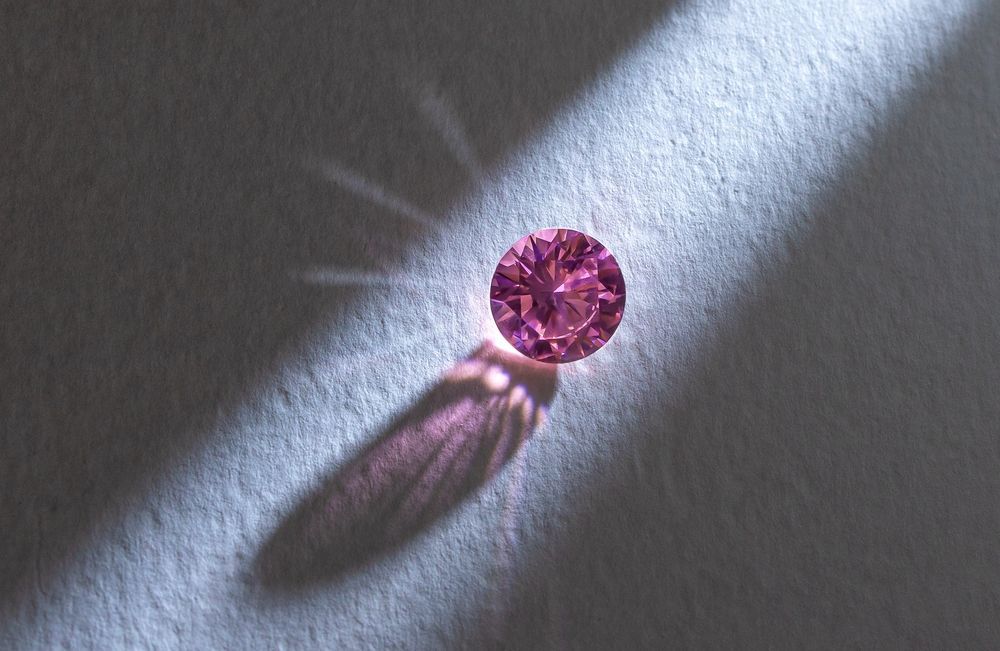 A Pink Diamond is Casting a Shadow on a White Surface — K. Smith & Son Jewellers In Caloundra, QLD