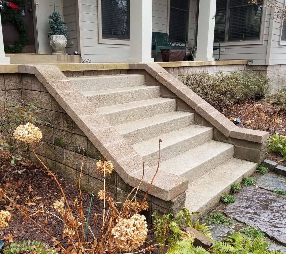 A set of stairs leading up to a porch of a house