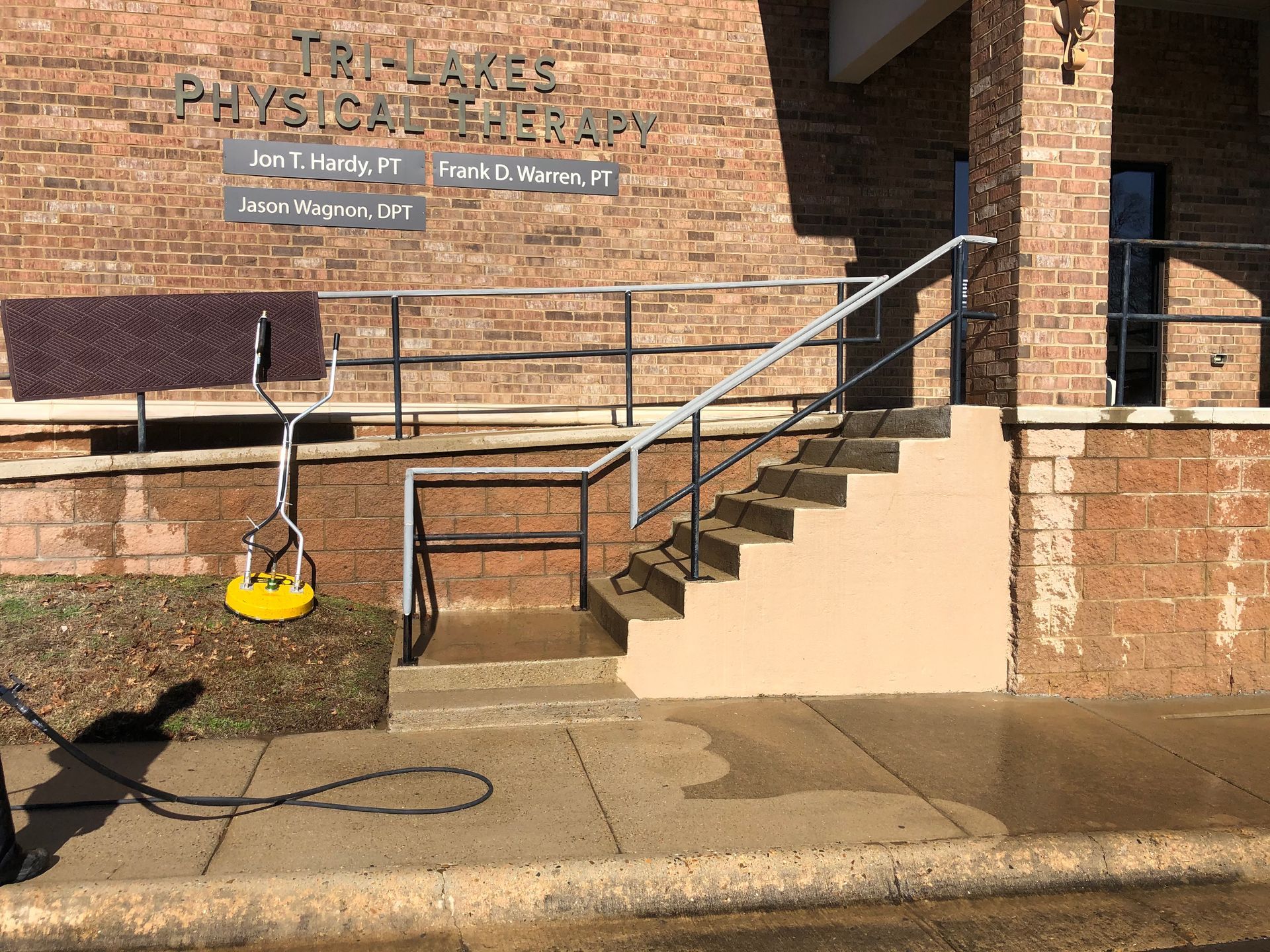A brick building with stairs leading up to it
