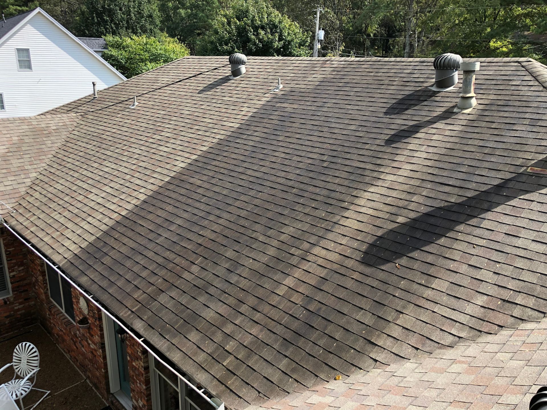 The roof of a house is very dirty and needs to be cleaned.