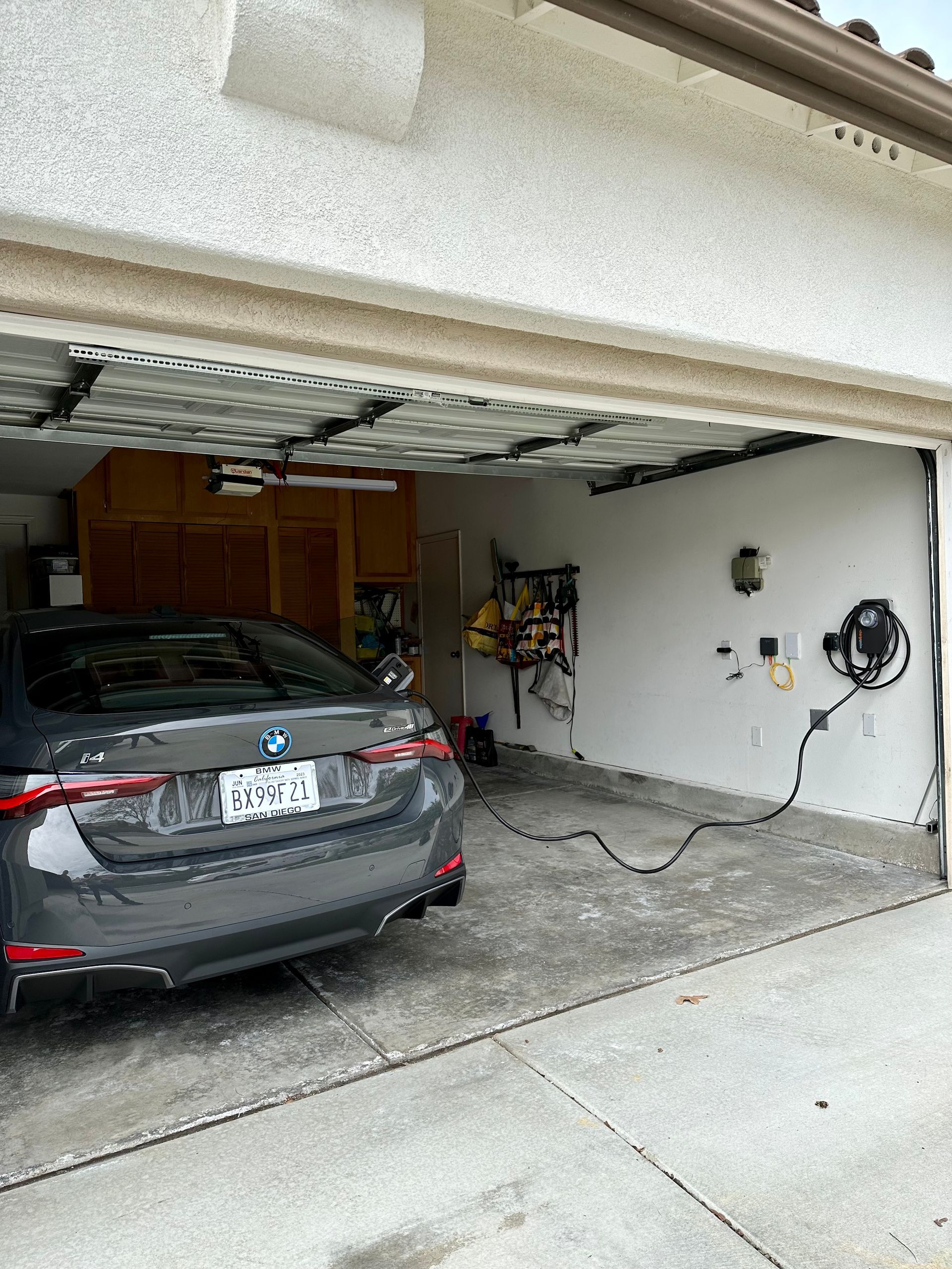 A car is parked in a garage with the door open.