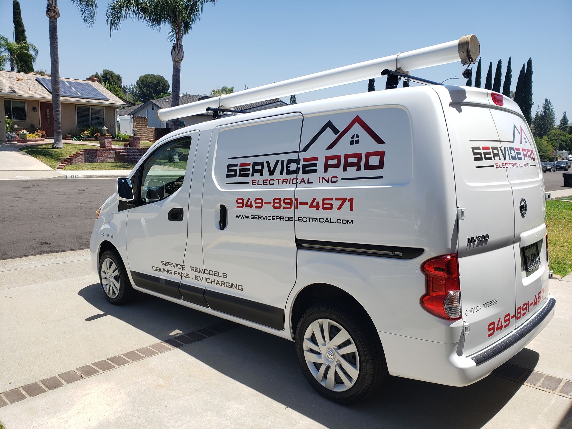 A white van with service pro written on the side is parked in front of a house.