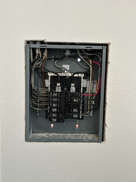 A close up of a electrical box on a wall.