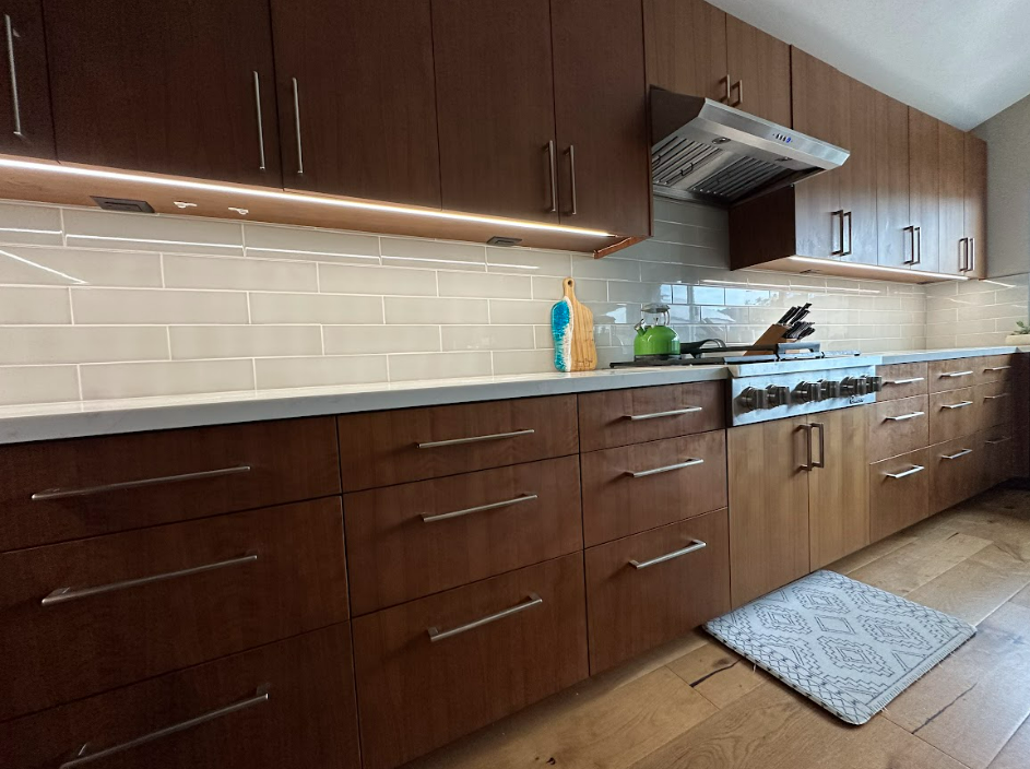 A kitchen with wooden cabinets and a stove top oven