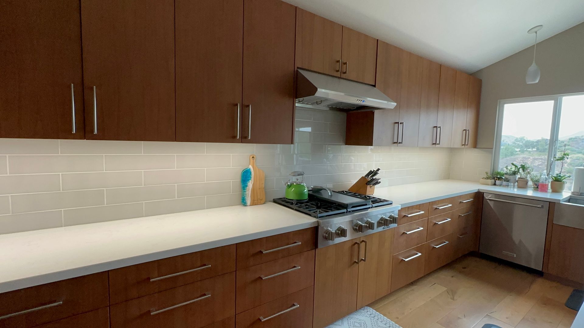 A kitchen with wooden cabinets and a stove top oven.