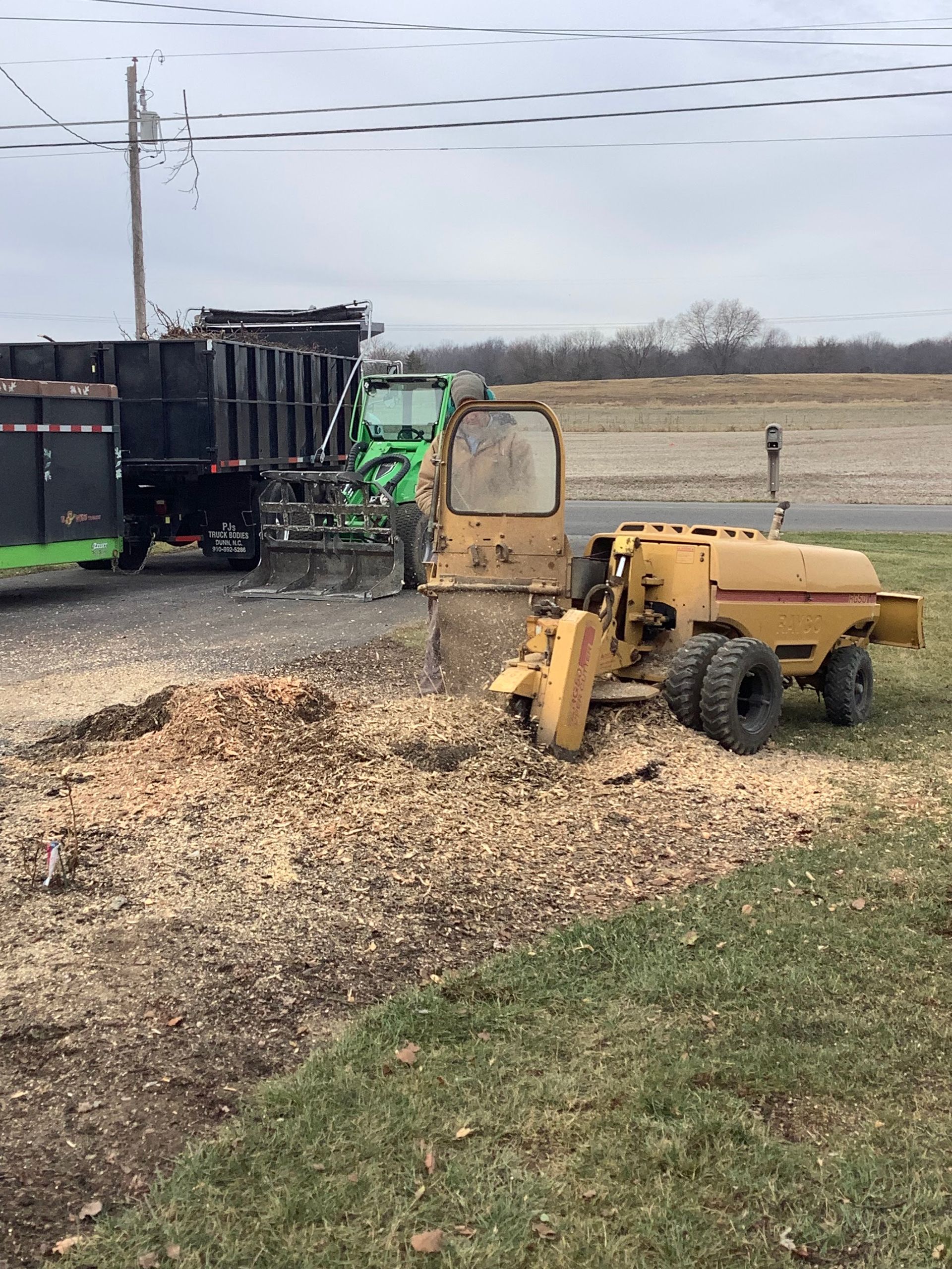 A man in a plaid shirt is using a laptop