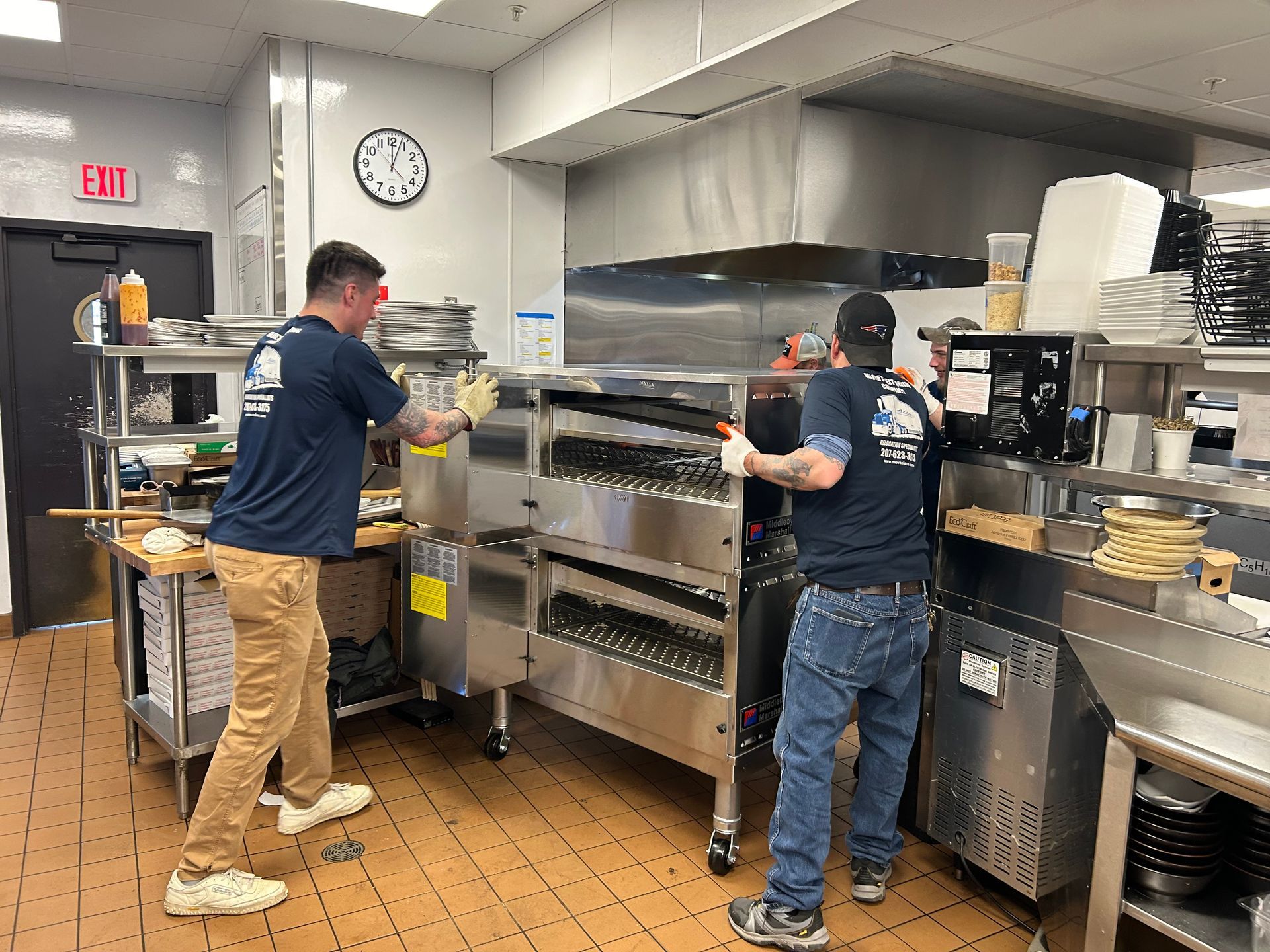 A group of men are working in a restaurant kitchen.