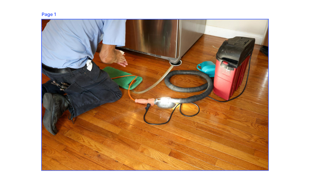 A stainless steel refrigerator is sitting on a wooden floor in a kitchen.