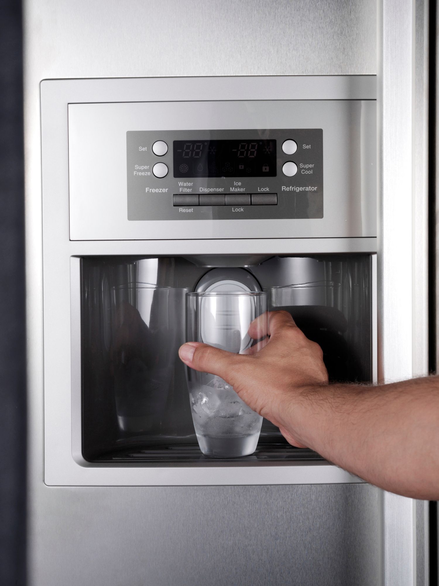 A view of an homeowner getting ice out of an ice machine.