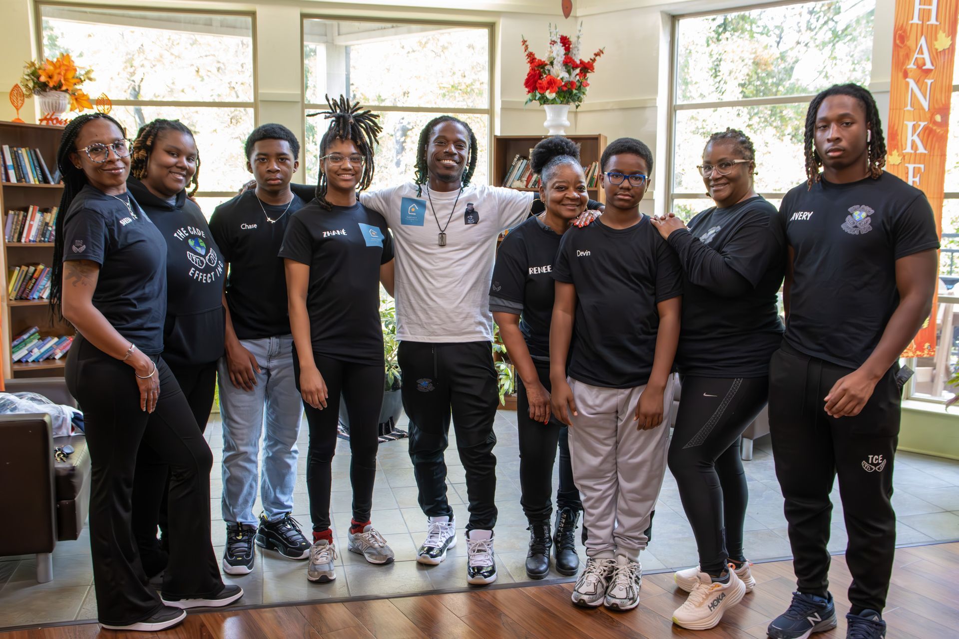 A group of people are posing for a picture in a room.