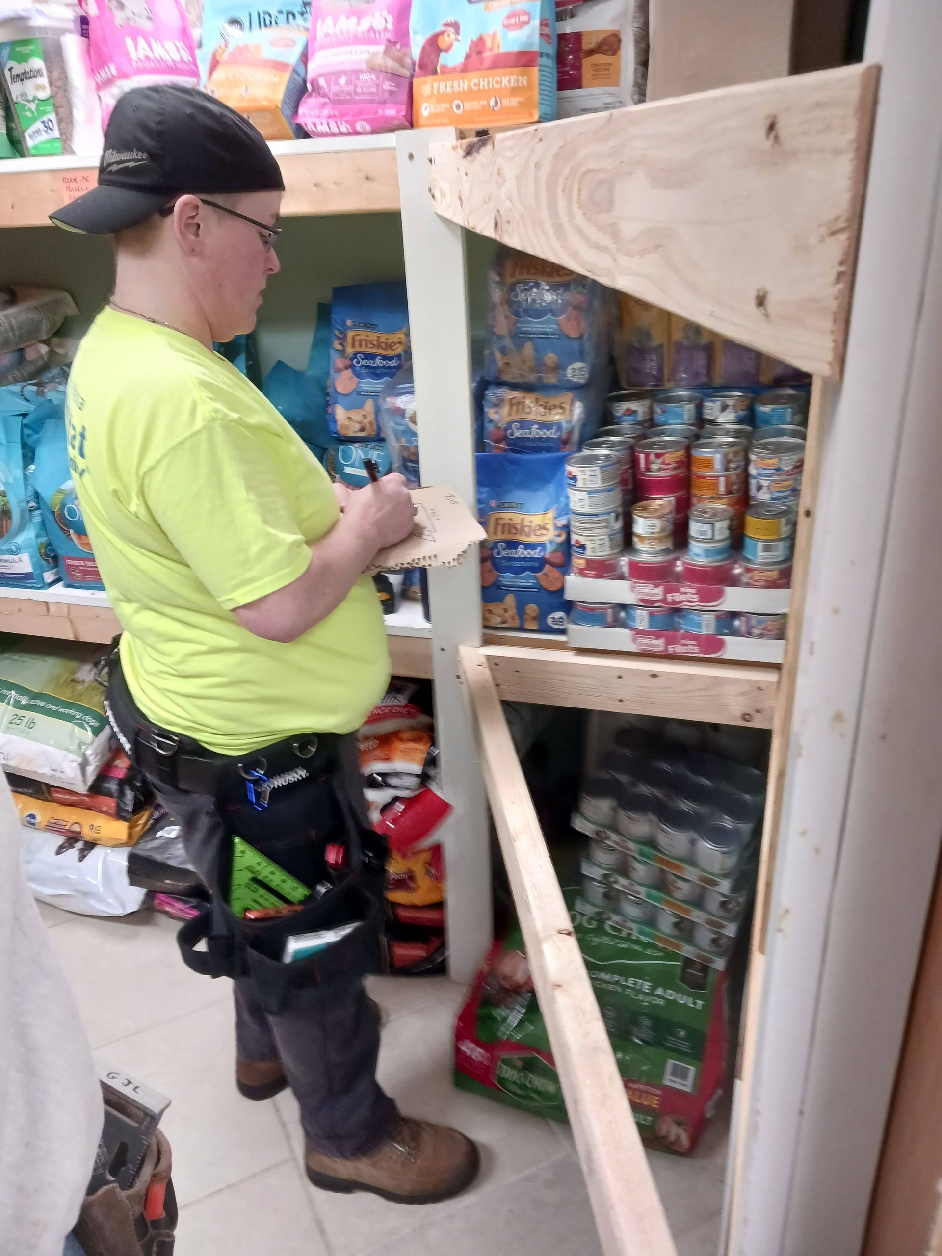 Jennifer measuring shelves at Manchester Animal Shelter, Feb. 2024