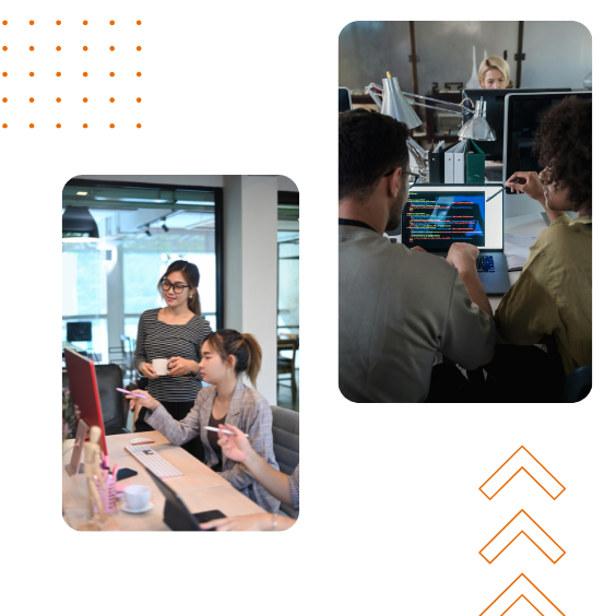 A group of people are sitting around a table with computers