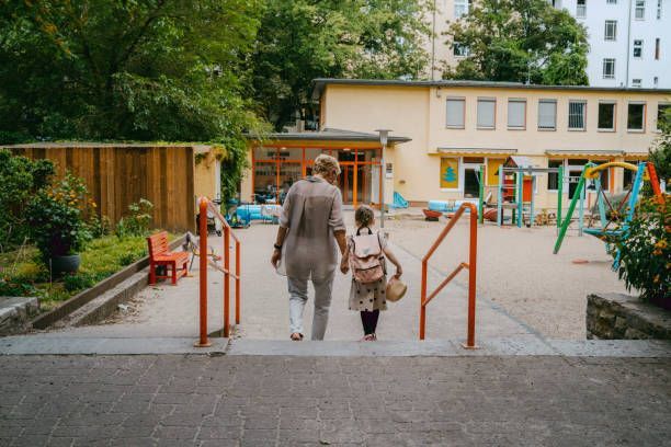 A woman with a granddaughter walking towards her preschool, the Learning Tree Schools in West Jordan
