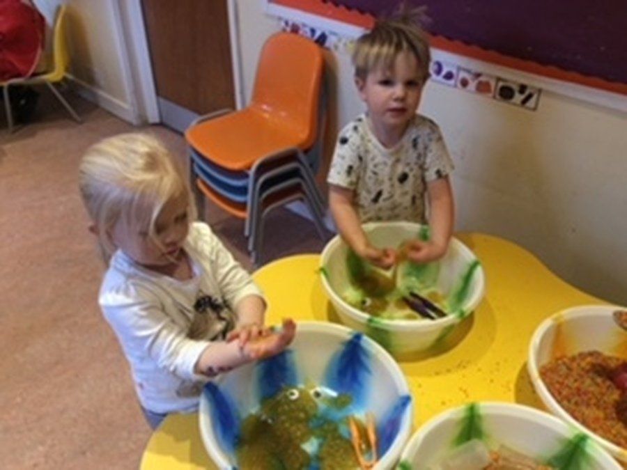 two kids messing with the food items
