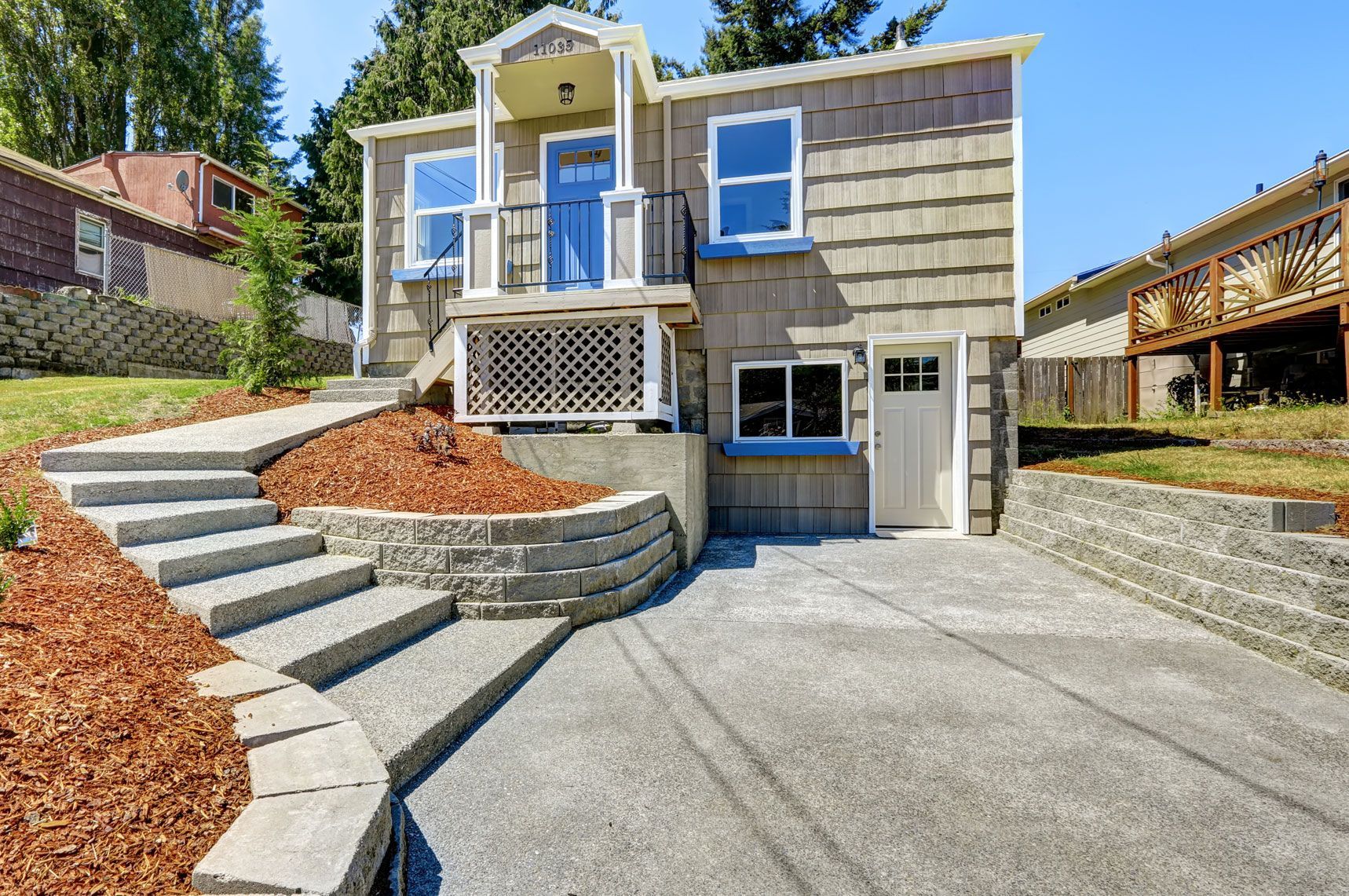 house with walkout deck and concrete walkway