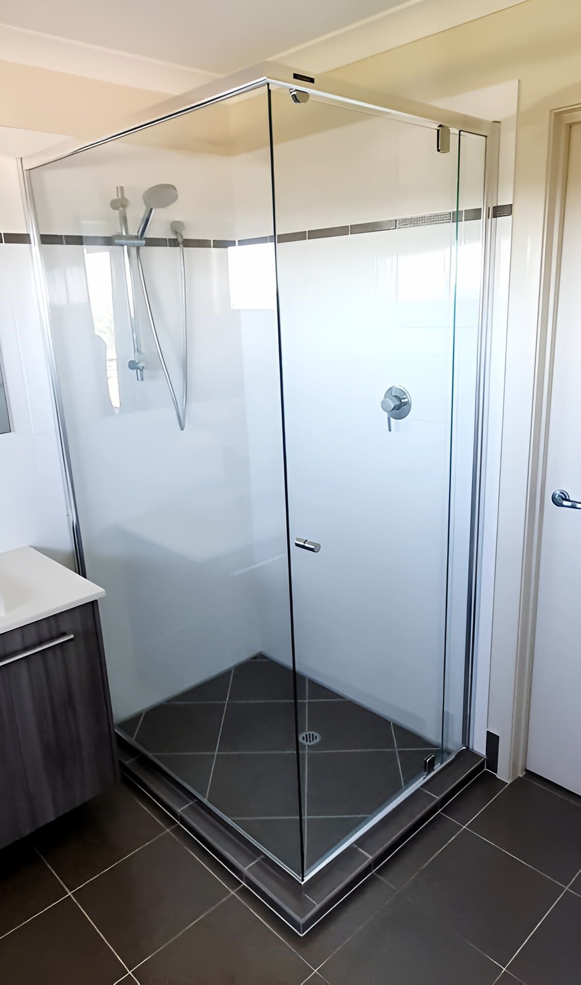 A Bathroom With A Shower Stall And A Sink — Mobile Shower Door Doctor In Caloundra, QLD