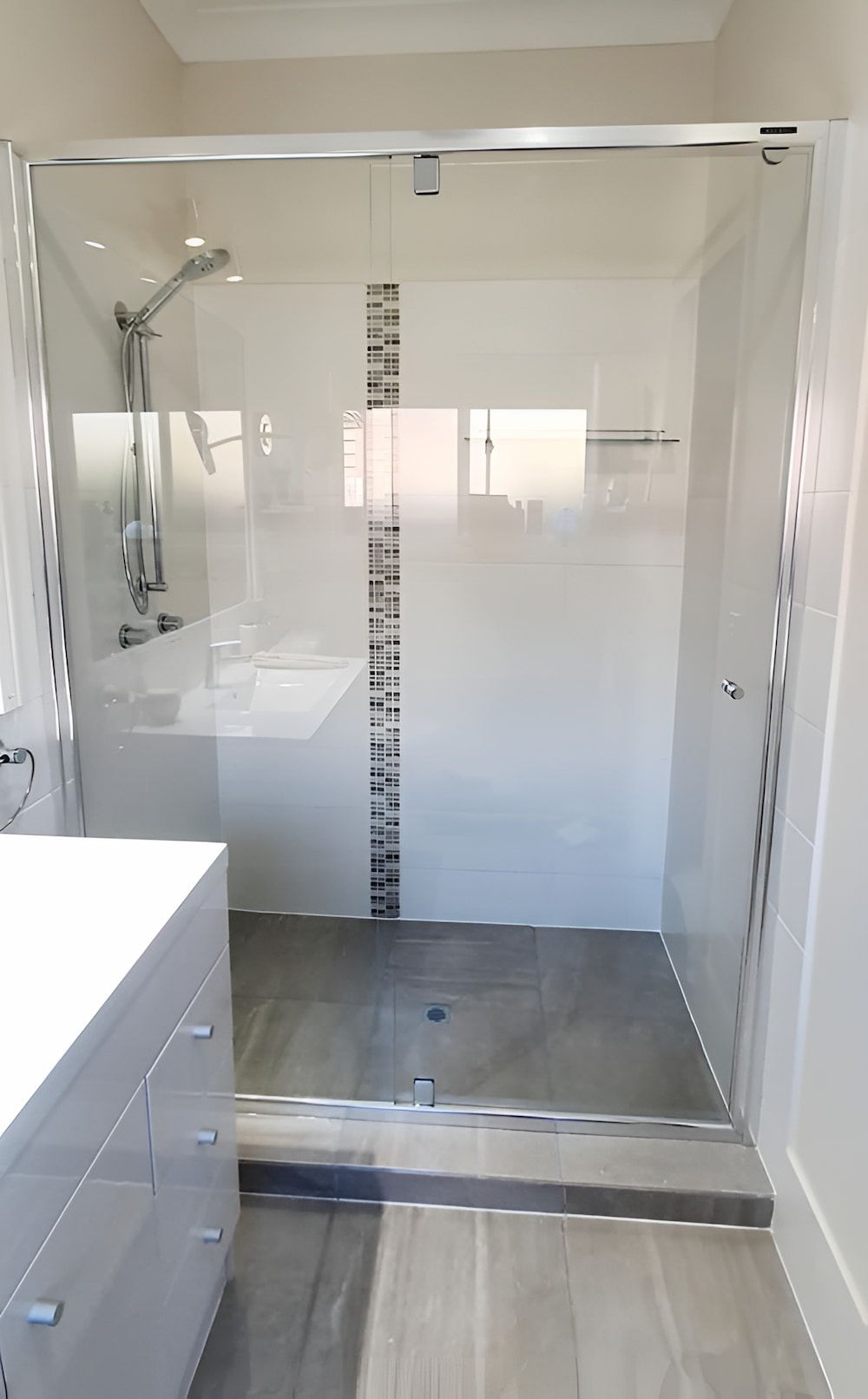 A Bathroom With A Walk In Shower And A Sink — Mobile Shower Door Doctor In Caloundra, QLD