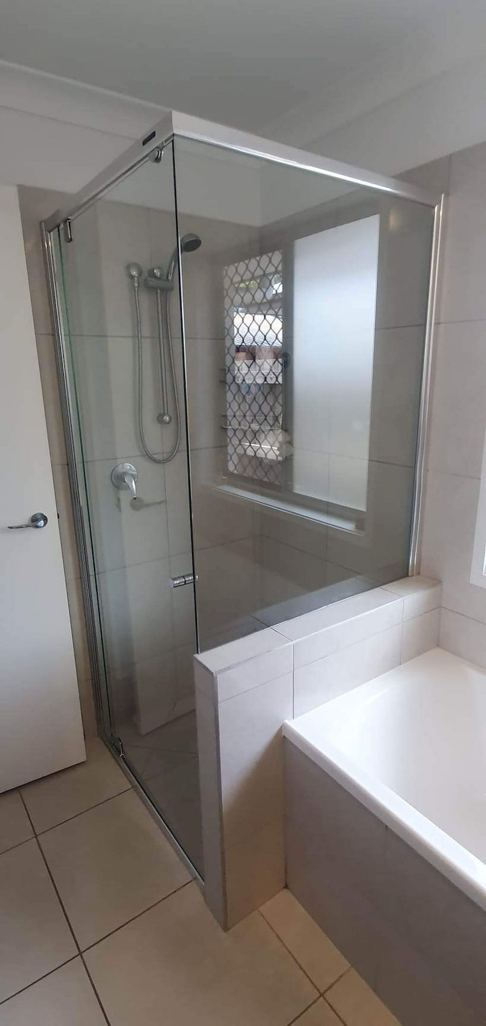A Bathroom With A Bathtub, Shower And Mirror — Mobile Shower Door Doctor In Mountain Creek, QLD