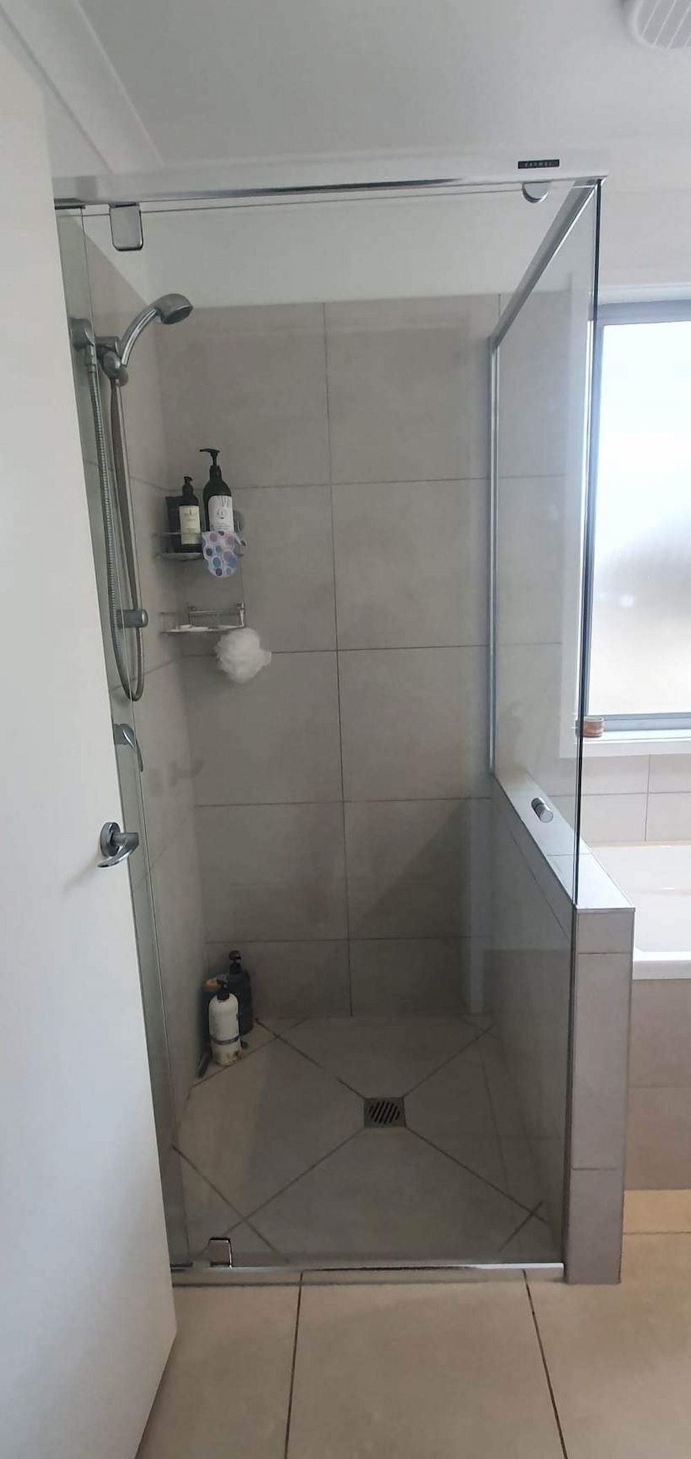 A Bathroom With A Walk In Shower And A Window — Mobile Shower Door Doctor In Mountain Creek, QLD