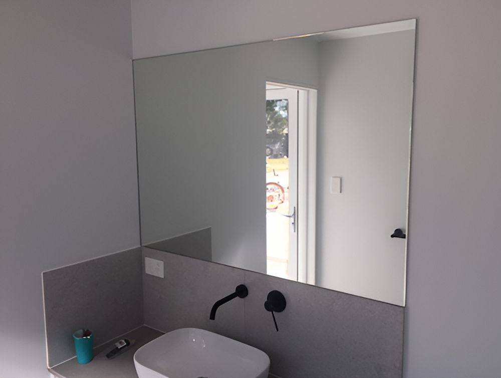 A Bathroom With A Sink And A Large Mirror — Mobile Shower Door Doctor In Mountain Creek, QLD