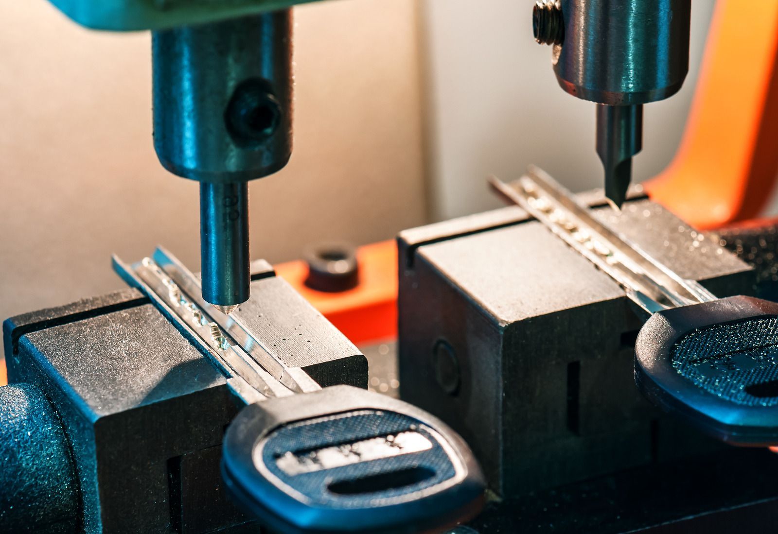 A close up of a key being cut on a machine.