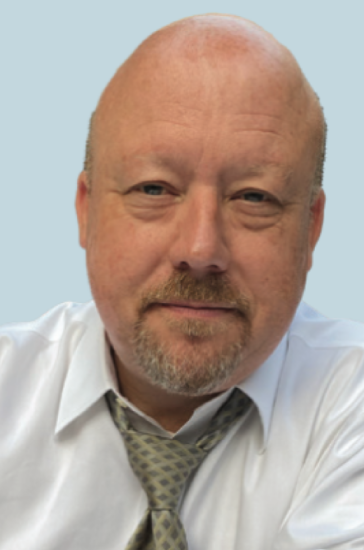 A bald man with a beard wearing a white shirt and tie
