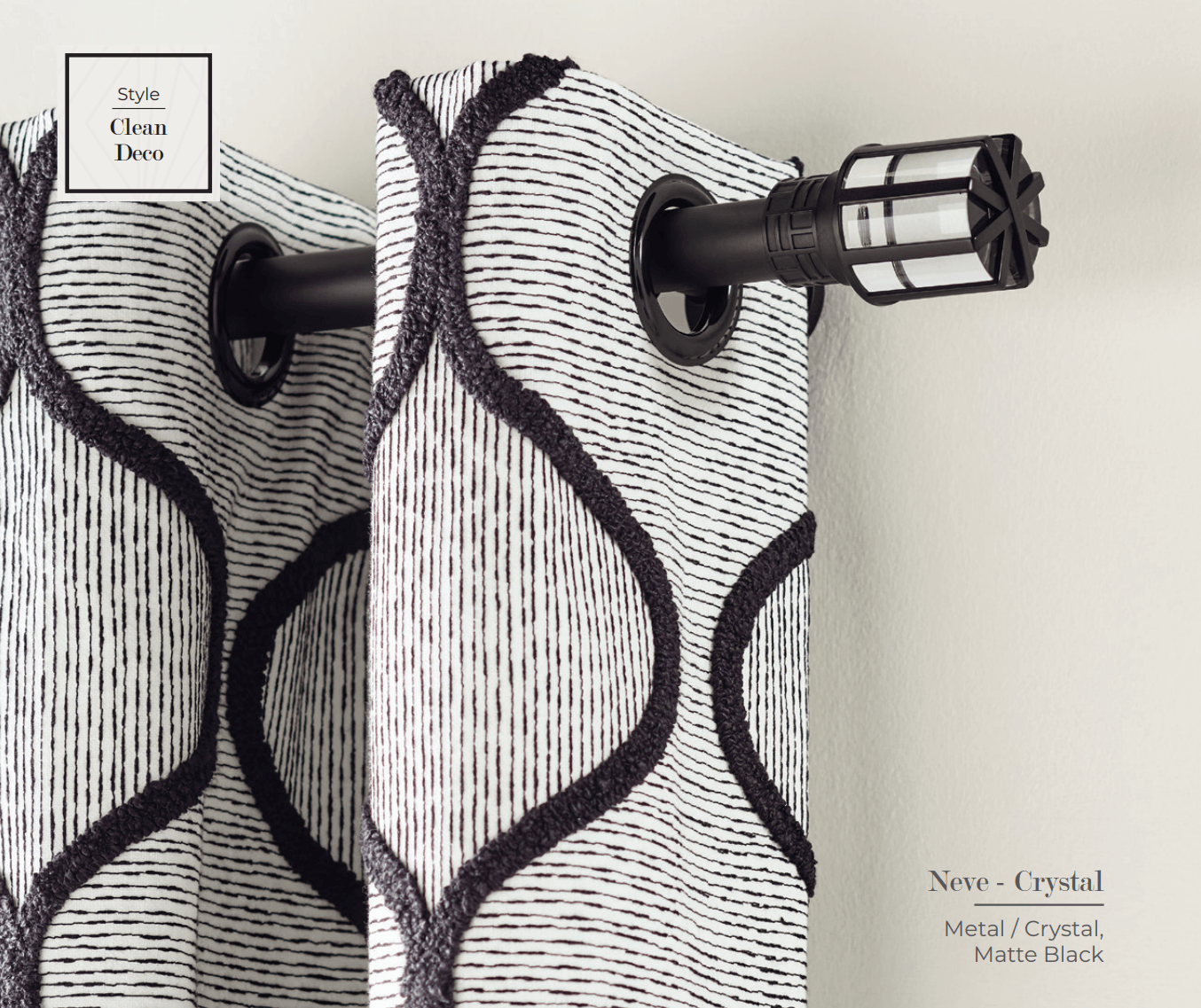 Two curtains with a black and white pattern hanging from a decorative rod.