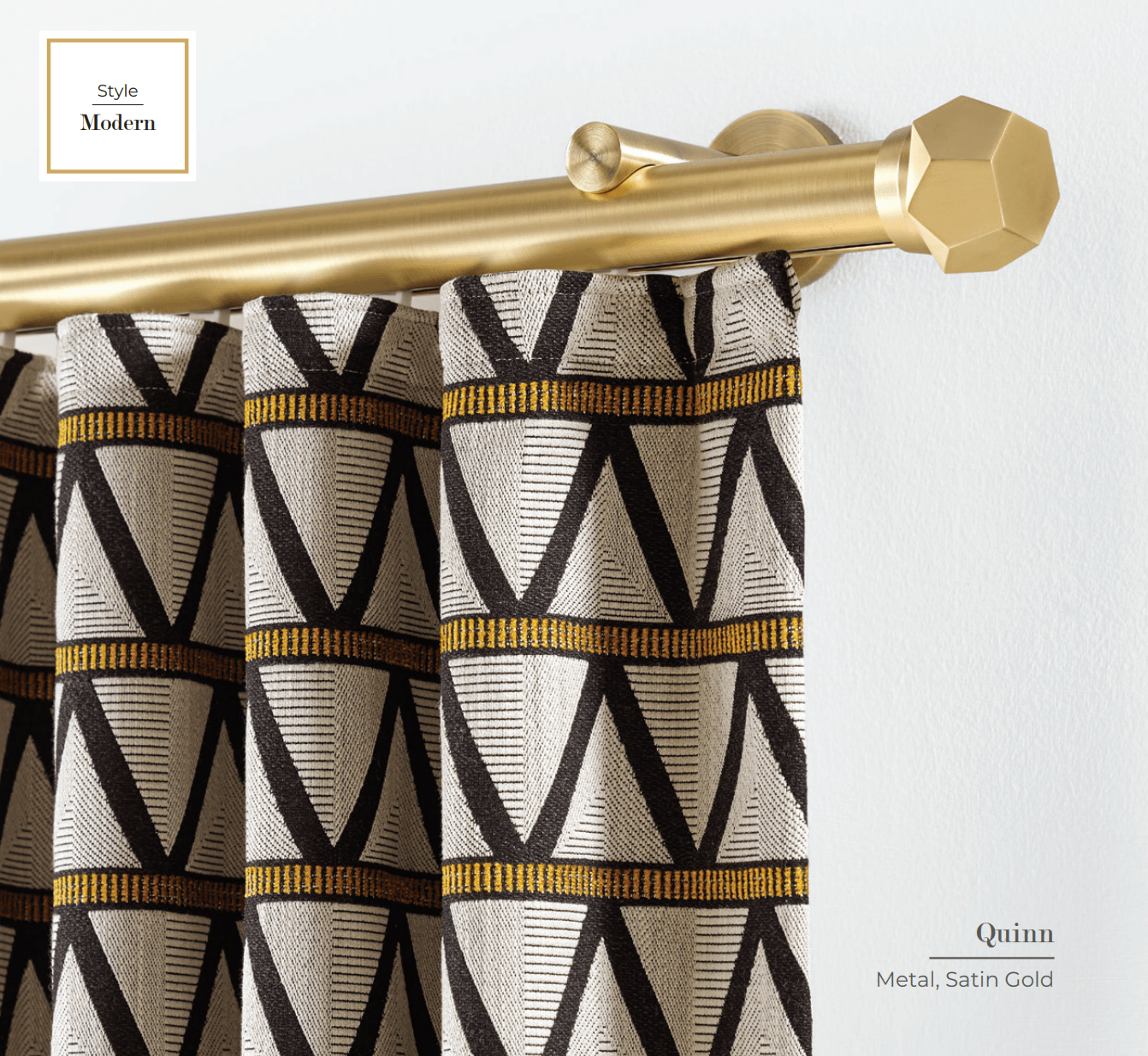 Gold curtain rod with geometric-patterned curtains.