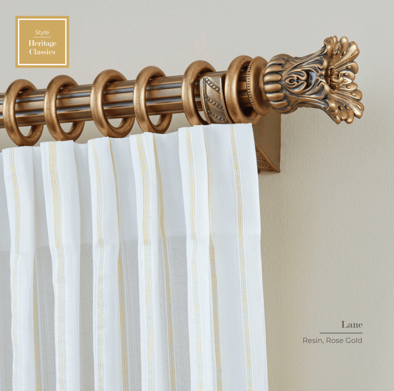 Gold curtain rod with white striped curtain.