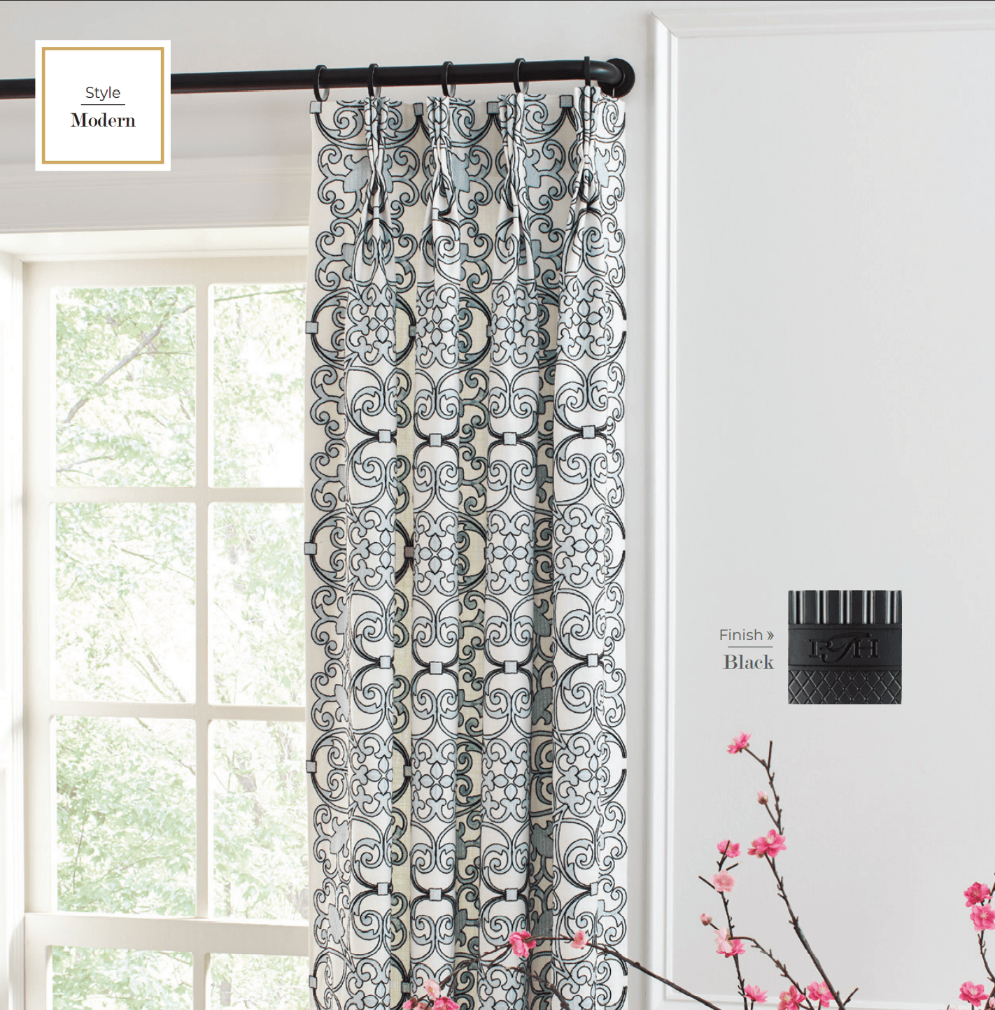 Window with blue and white patterned curtain, black rod, and a black candle holder.