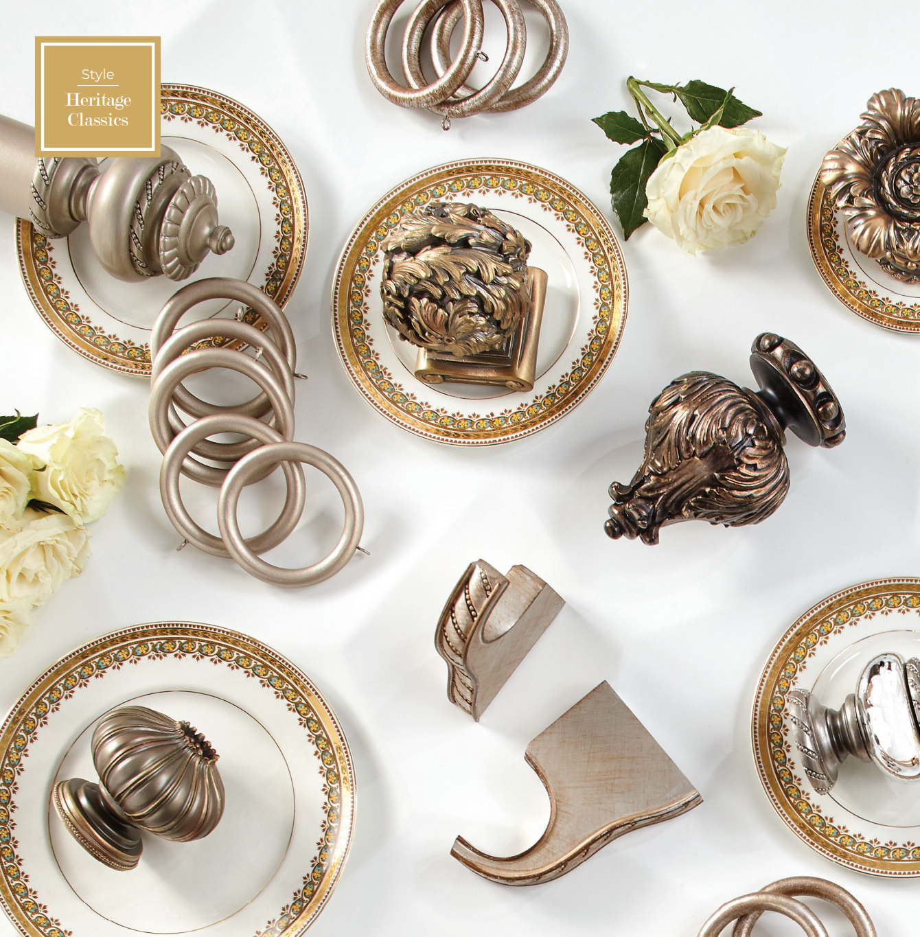 Assortment of decorative curtain hardware in gold and bronze tones displayed on china plates.