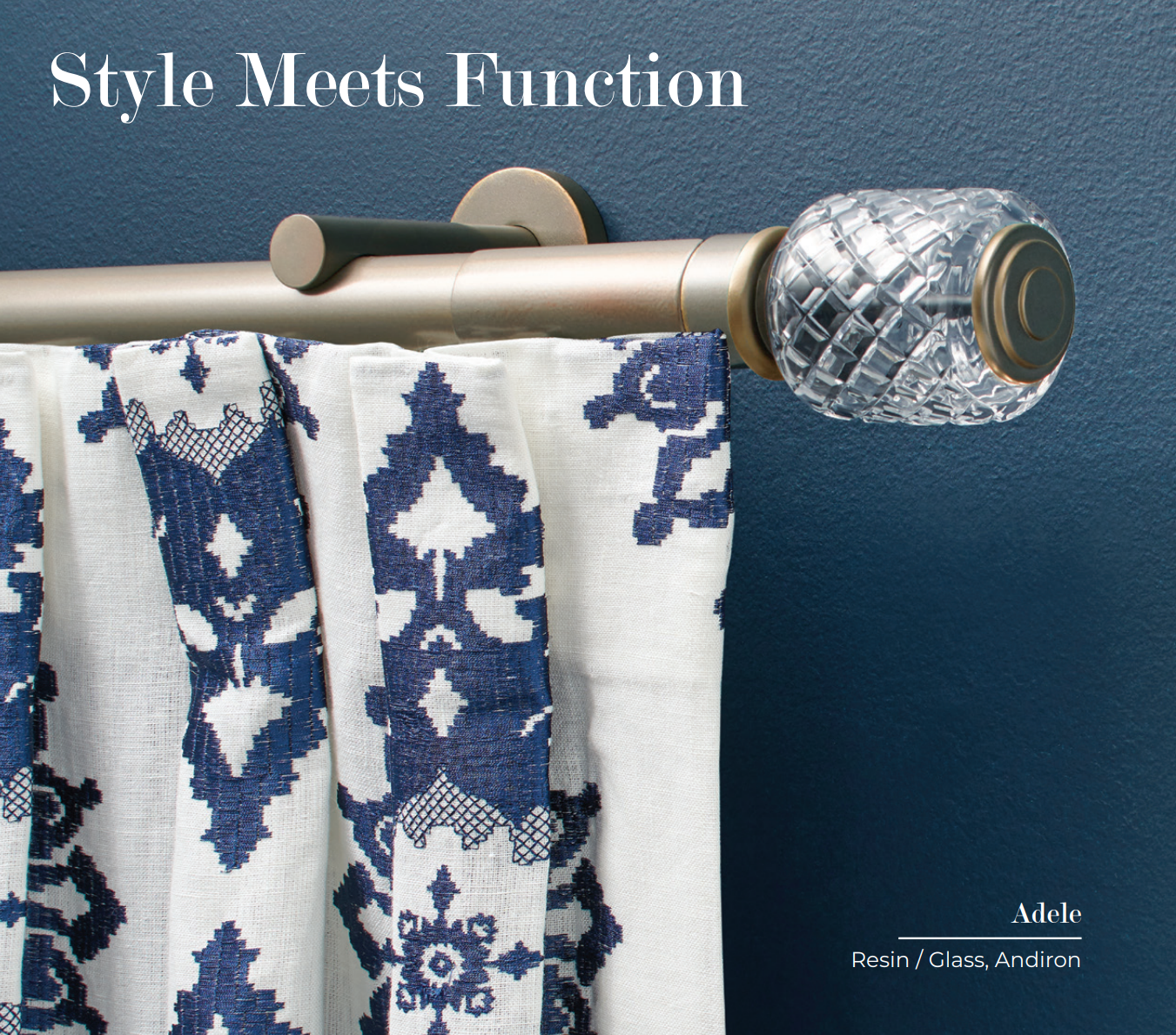 Curtain rod with a crystal finial and patterned blue and white curtains against a dark blue wall.