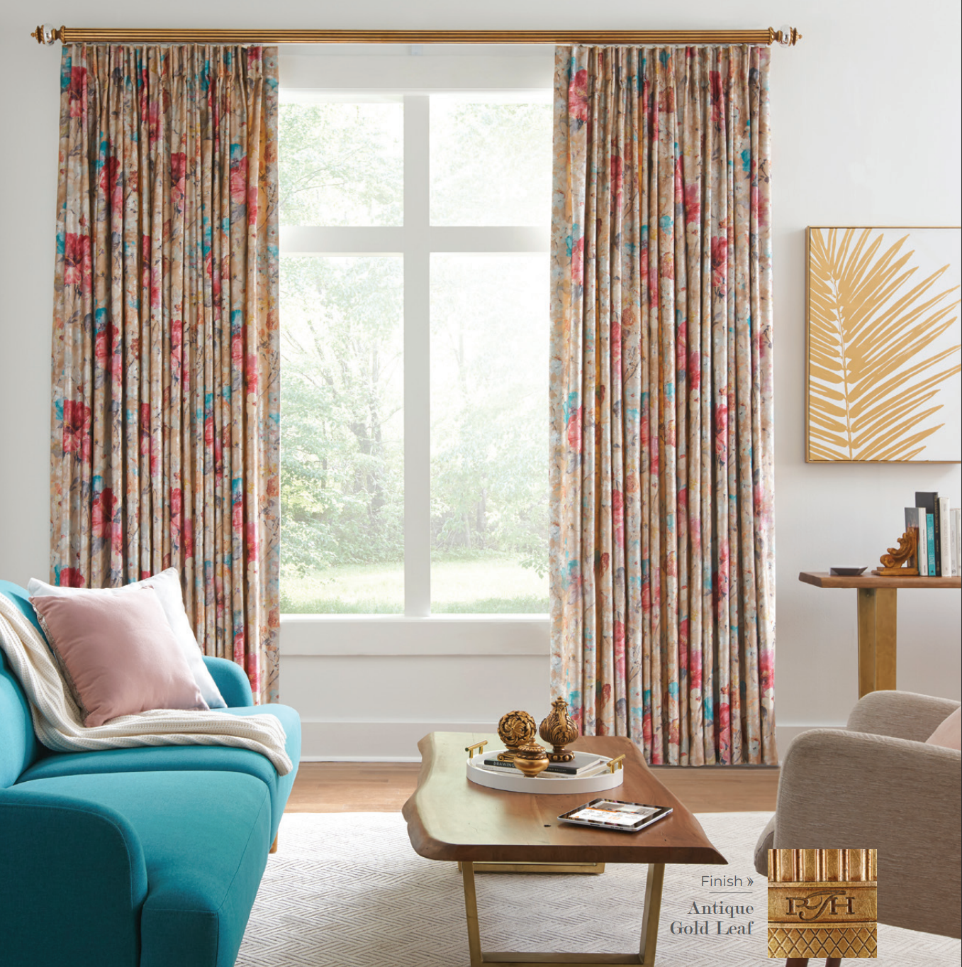 Living room with floral curtains, teal couch, and gold palm artwork.