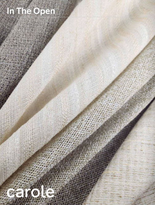Close-up of folded fabric in shades of gray and cream.
