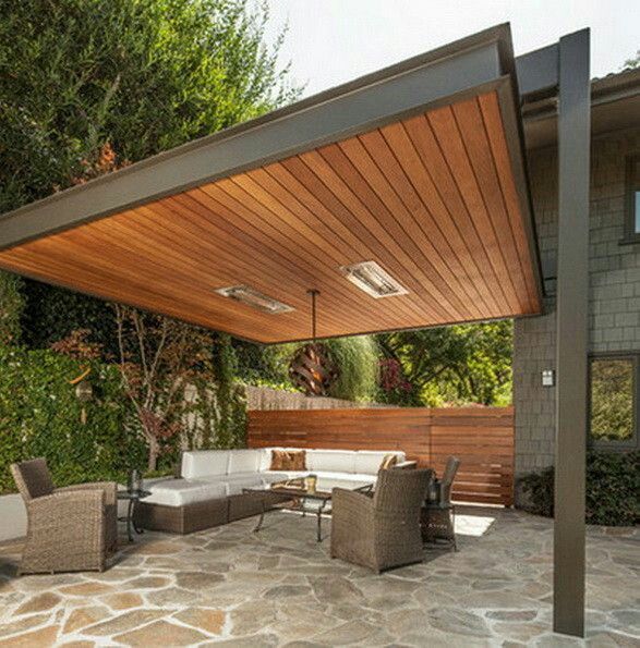 Patio with a modern wood-lined pergola, outdoor seating, and heaters.