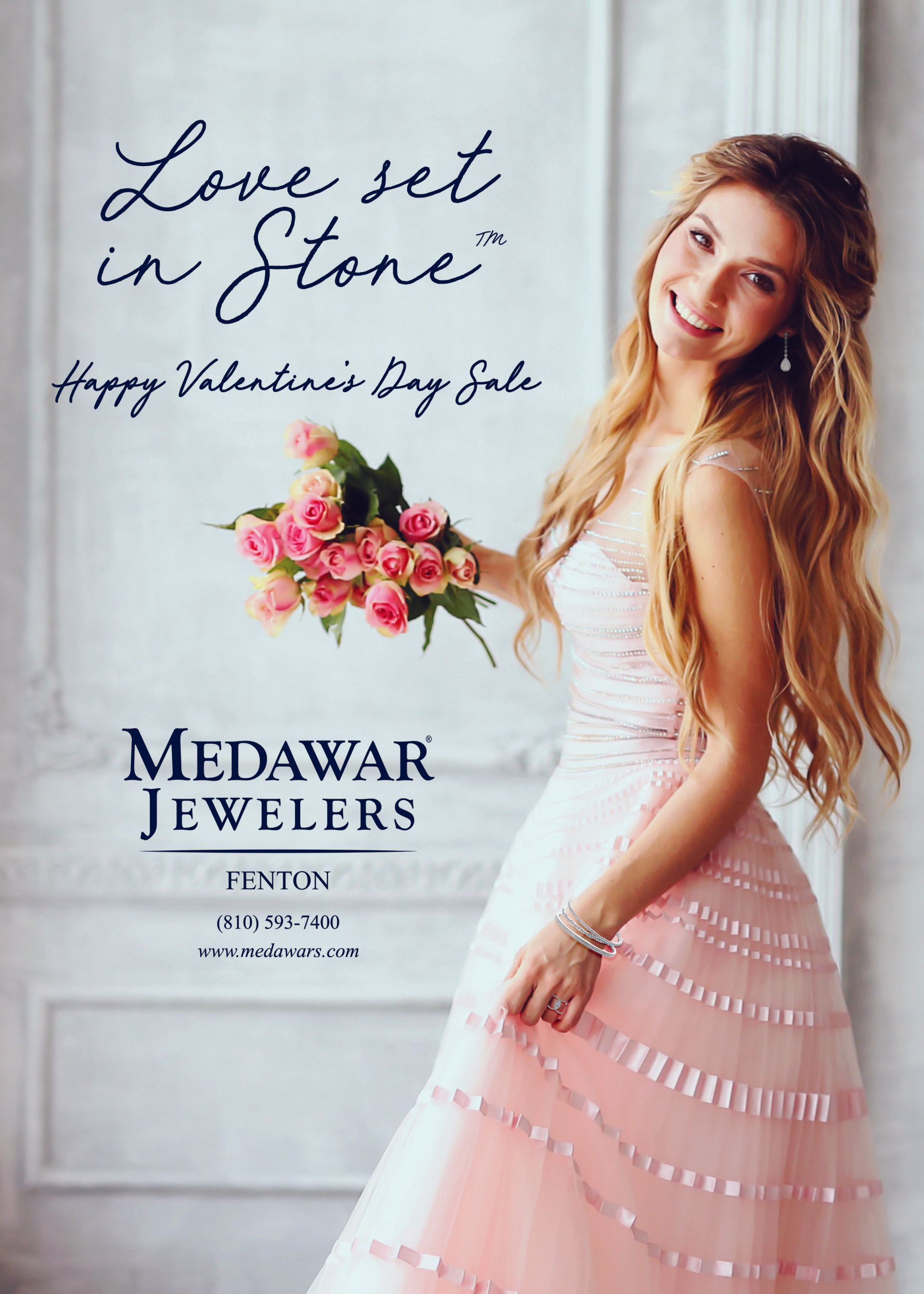 A woman in a wedding dress is holding a bouquet of pink roses.