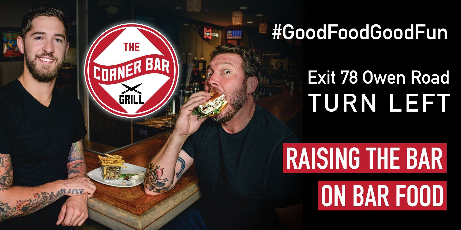 Two men are sitting at a table eating food at the corner bar grill